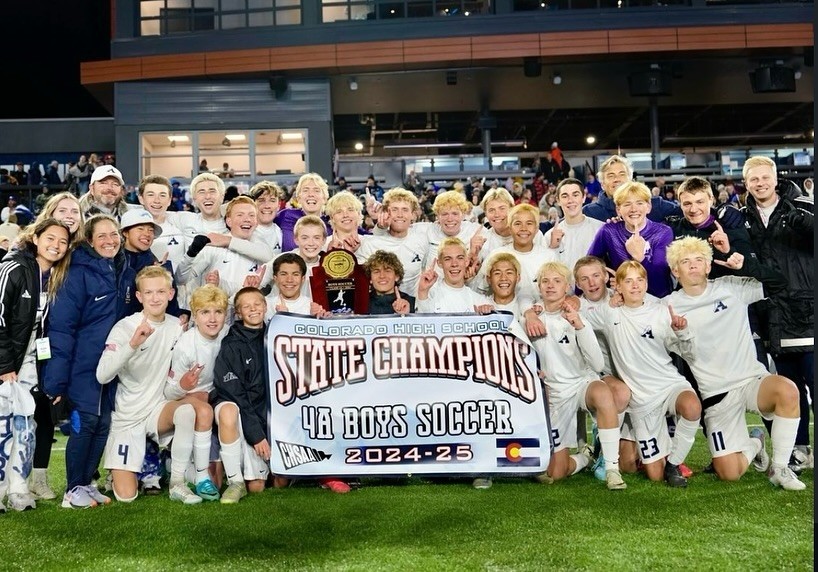 The boys soccer team poses after winning a state championship game.